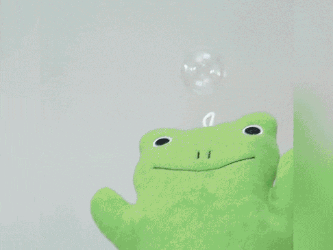 Look at that cheeky chappy! A jolly green frog puppet sits patiently, a single, shimmering bubble hovering just above its head. Ready for some bubbly fun, I say!