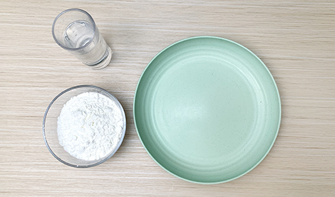 Gather your ingredients, my friend! We'll need a bowl of cornflour, a glass of water, and a plate – a nice big one for all that splashy fun. Let's get that gloopy goodness going!