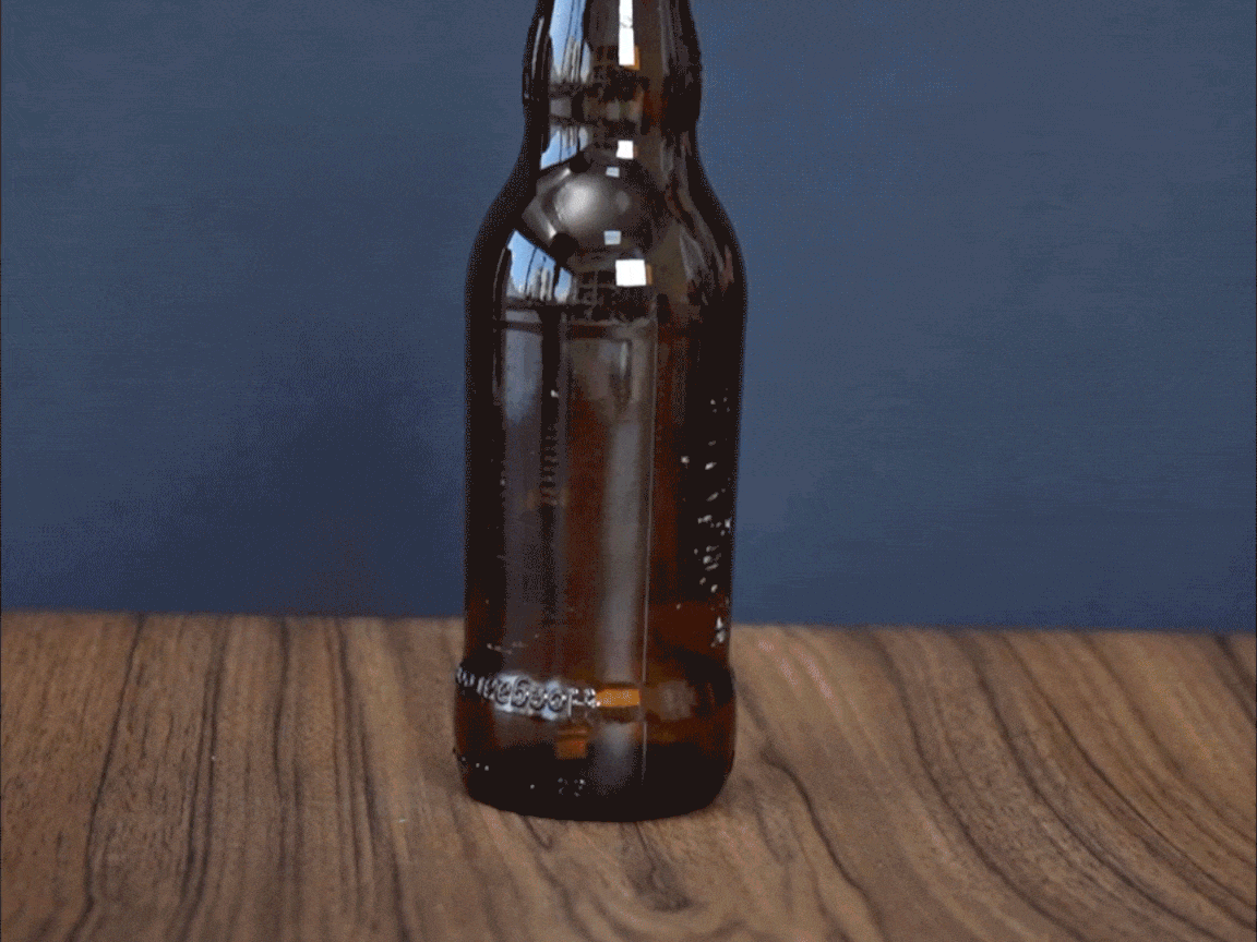Blimey, look at that! The bottle's been given a bit of a heat treatment, and the string's been burnt away. It's all rather dramatic, innit? Let's see what happens next!