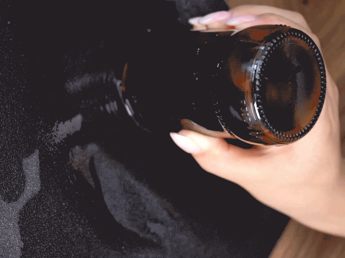 Ooh, look at that! A hand is carefully pressing down on the neck of a bottle, and something is definitely happening. It’s all rather mysterious, innit? Let's see what happens next!