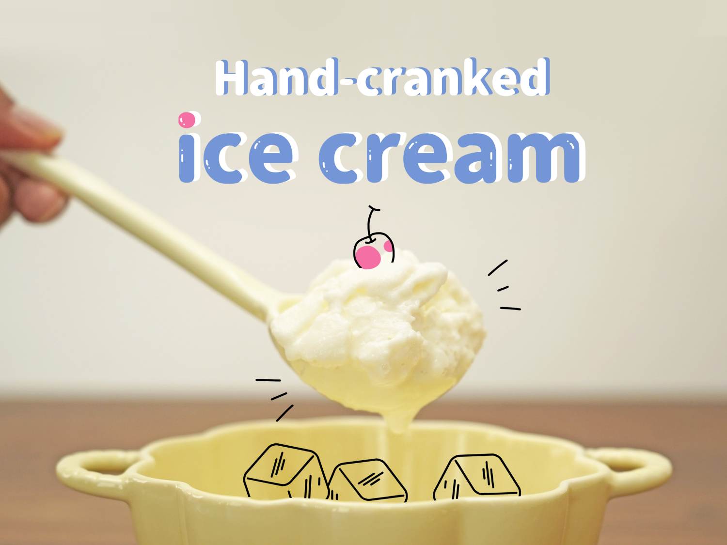 A hand holds a white spoon filled with a scoop of vanilla ice cream, topped with a cartoon drawing of a cherry. The spoon is positioned above a pale yellow bowl. Inside the bowl, a few cartoon ice cubes are drawn. The wooden table surface is visible beneath the bowl. Text at the top reads Hand-cranked Ice Cream. The image likely illustrates the process or result of making homemade ice cream.