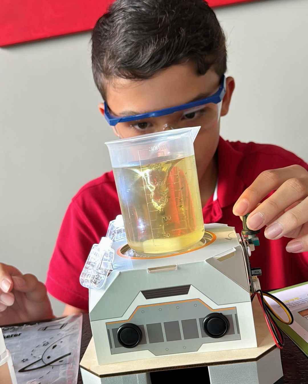 Image of kid conducting an experiment with the Chemical Tornado STEAM kit